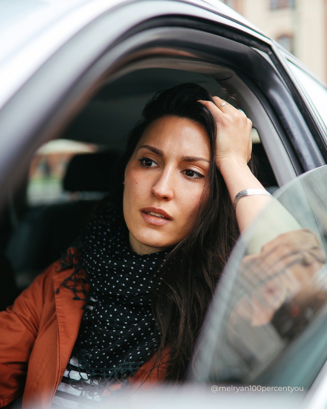 woman holding her head, stuck in another traffic jam wondering what next.